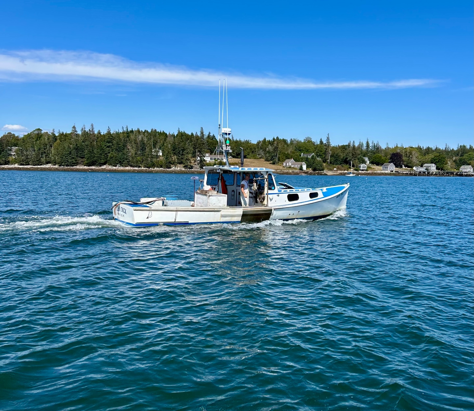Maine lobster boat on blue water